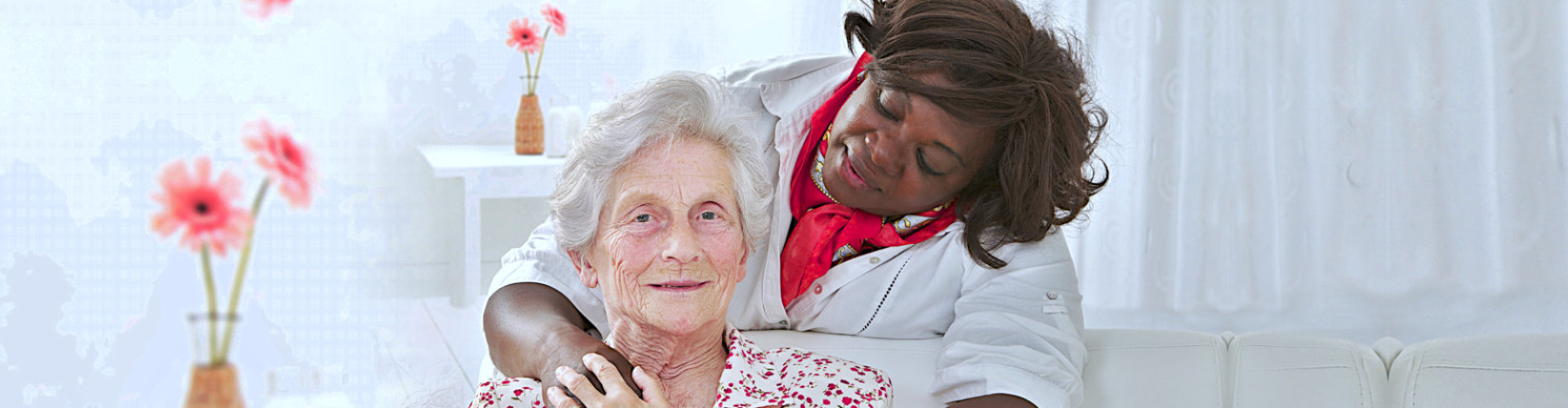 female caregiver hugging senior woman